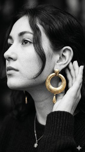 A woman in profile touches her earring in minimalist line art