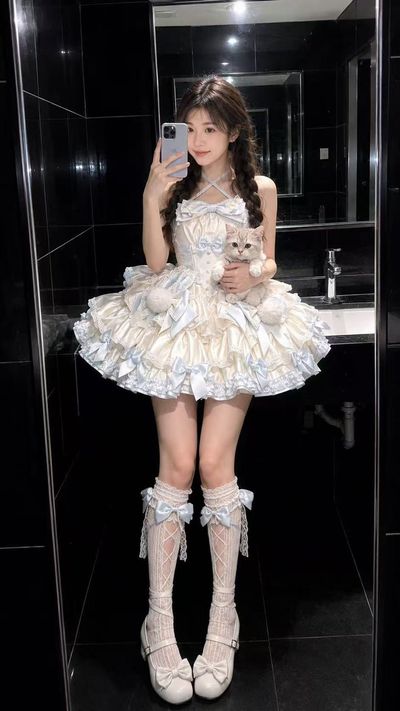 A lolita kitten mirror selfie in glossy black tile bathroom