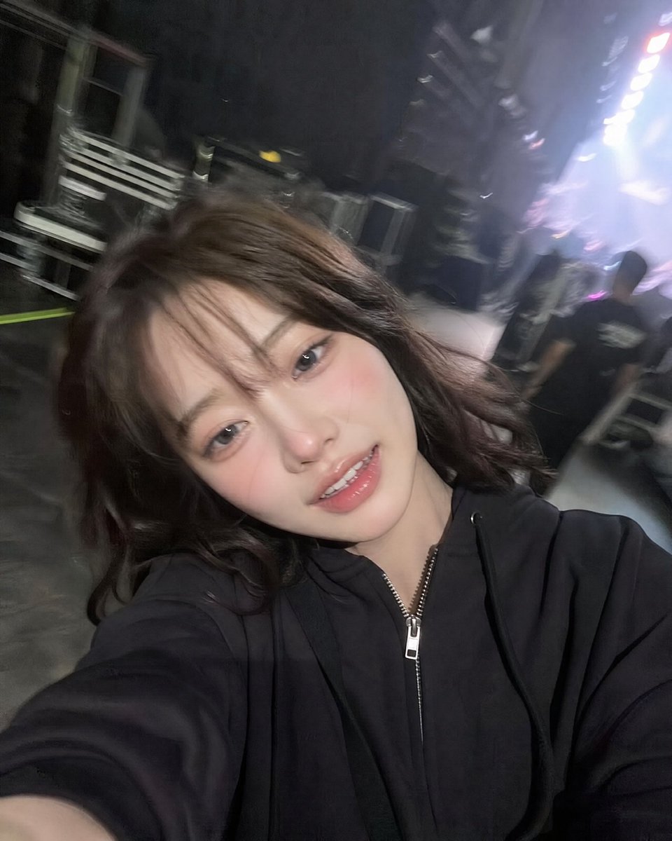 Tired singer laughs after concert in backstage corridor selfie