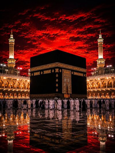Kaaba glows with golden light as worshippers circle at twilight