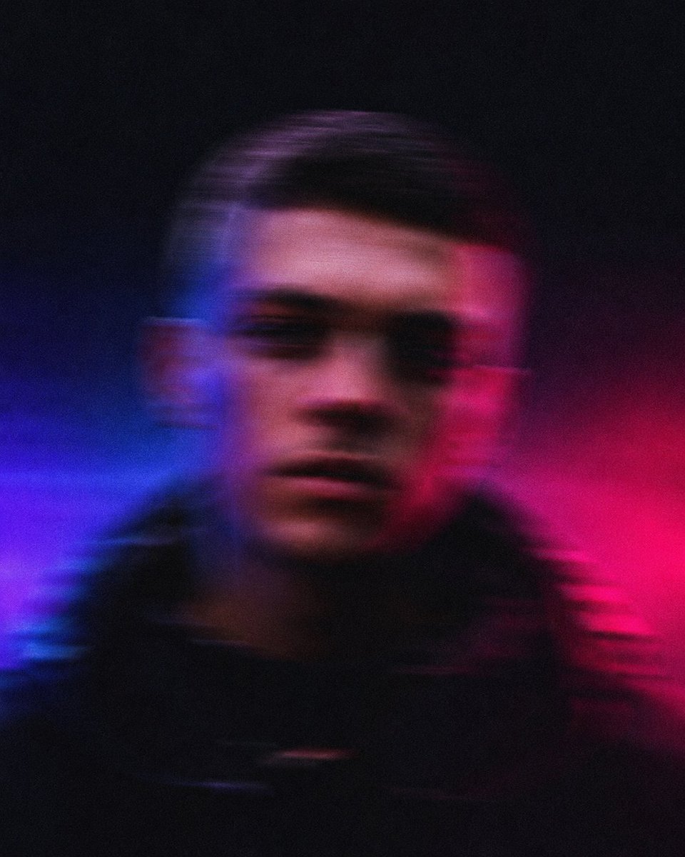 Blurred European man in streetwear faces camera with intense motion blur