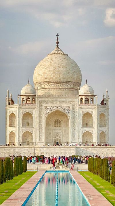 Golden hour illuminates the Taj Mahal's perfect symmetry