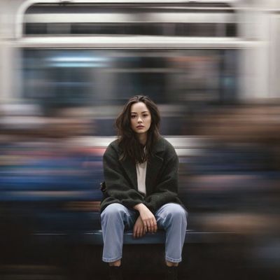 Stillness Amid Motion: Portrait on a Subway Platform