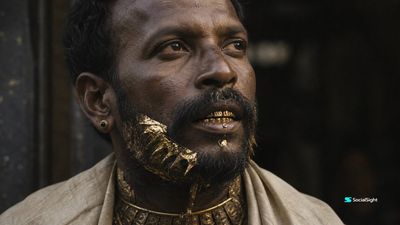 A middle-aged man with gold teeth stares upward in a dim doorway