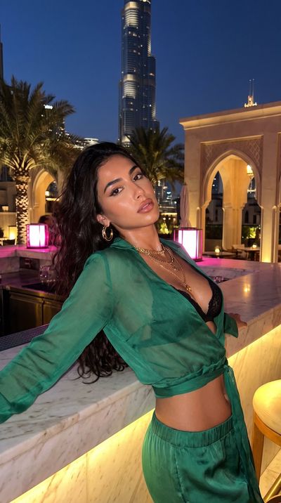 Jewelry Designer Reclines on Marble Ledge in Dubai Night Glow