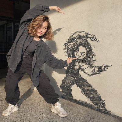Fashionable woman points at chibi wall doodle in golden sunlight