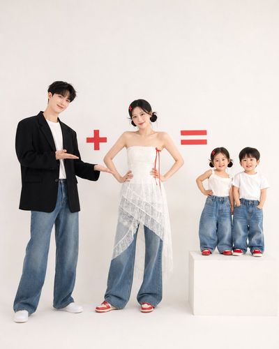 A Korean family poses in minimalist studio with red symbols