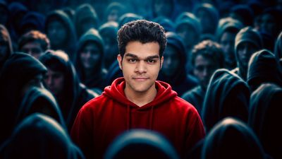 Red Hoodie Hero Stands Firm Amid Shadowy Hooded Crowd