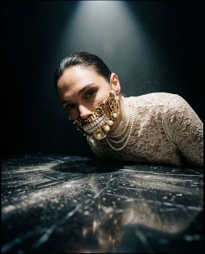 Looming aristocrat in gold mechanical smile, ground-level chiaroscuro