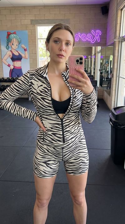 Elizabeth Olsen poses for a mirror selfie in zebra gym wear
