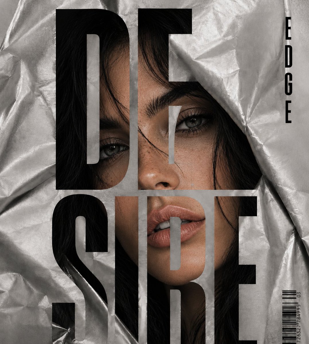 A striking face emerges from crumpled silver fabric behind bold typography