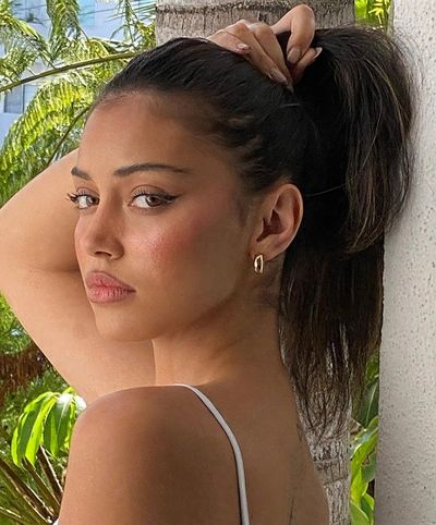 Side Profile Portrait of Woman with Sleek Ponytail in Tropical Light