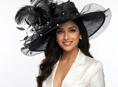 Indian woman in black hat wears white blazer for high fashion portrait