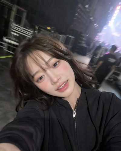 Tired singer laughs after concert in backstage corridor selfie