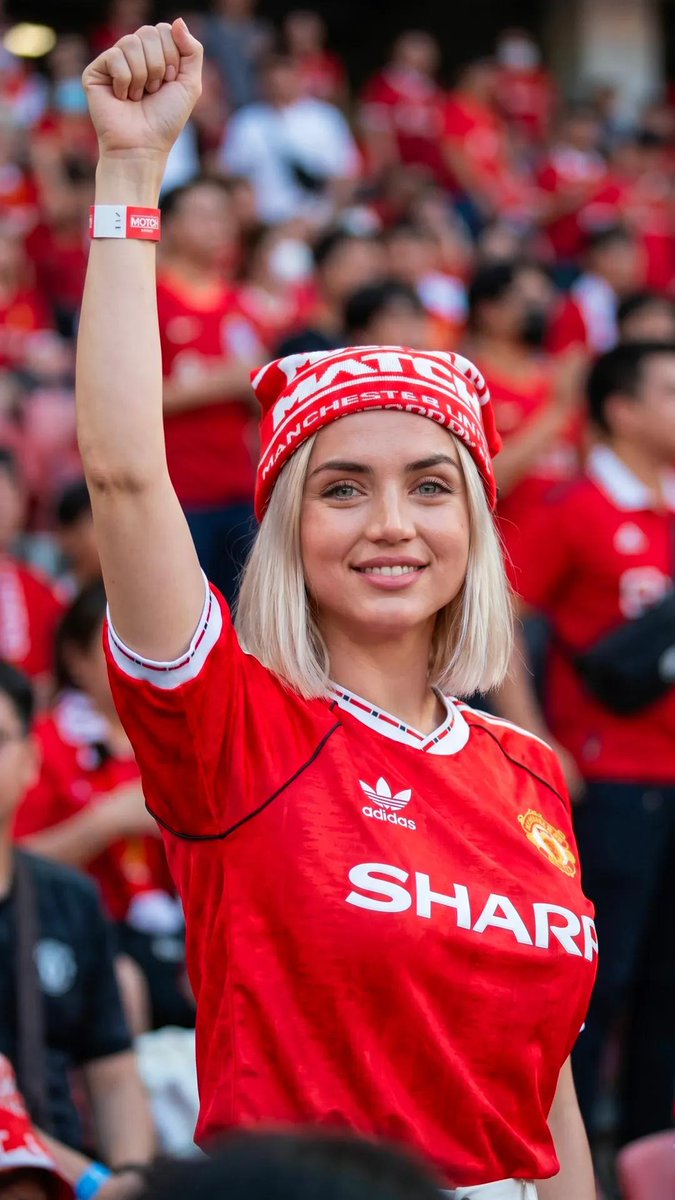 Red jersey gleams under sunlight at Old Trafford stadium
