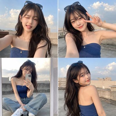 A young woman captures playful rooftop selfies during golden hour