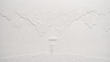 Blind embossed paper artwork casts subtle white shadows across textured surface