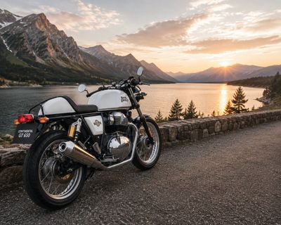 Vintage café racer parked by a mountain lake at golden hour
