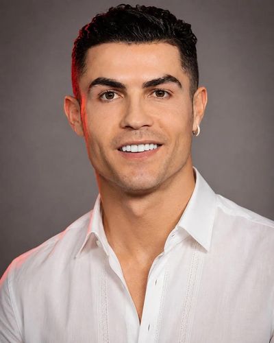 A world-class footballer poses confidently in a crisp white shirt