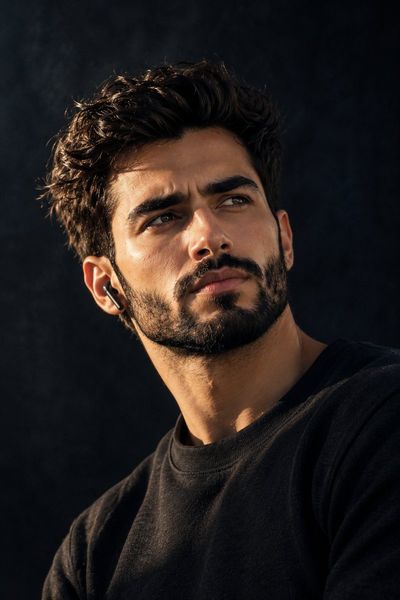 Cinematic portrait of a young man in dramatic side lighting