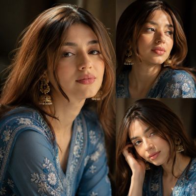 A young woman in blue kurta glows under golden window light
