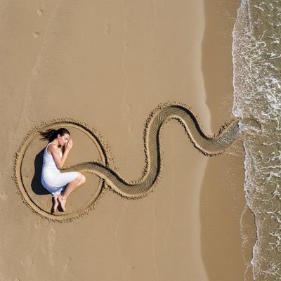 A Woman's Connection to the Sea in Sand Art