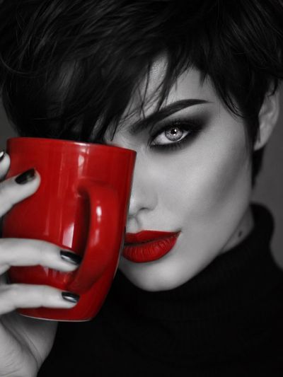 Bold red lips and mug contrast with monochrome portrait