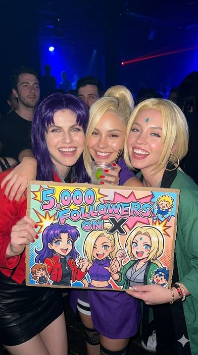 Neon Cosplay Celebration in a Crowded Nightclub