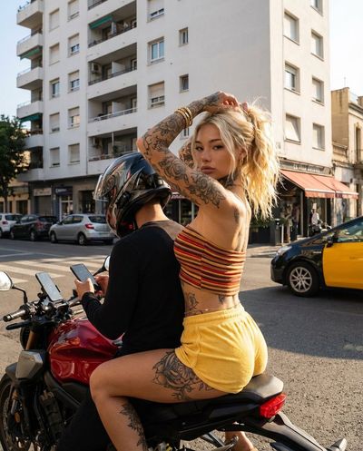 Tattooed Rebel on a Red Bike