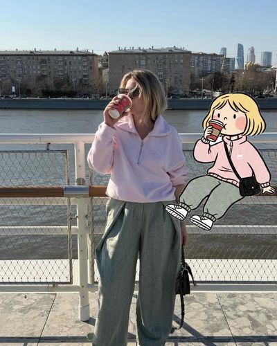 A stylish woman sips coffee beside a cartoon girl on a ferry deck