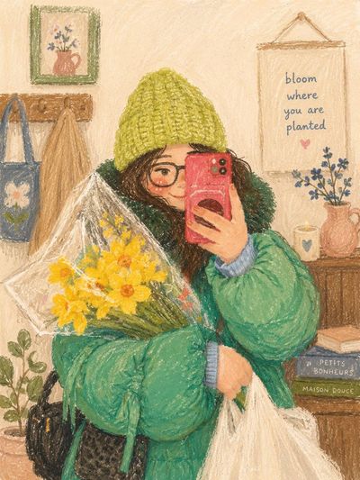 A girl in a beanie takes a cozy mirror selfie with flowers