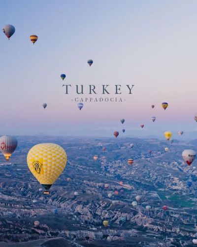 Turkey's Cappadocia floats under a pastel sunrise sky