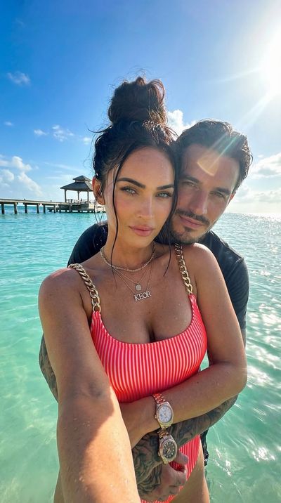 Megan Fox poses in neon swimsuit at tropical beach selfie