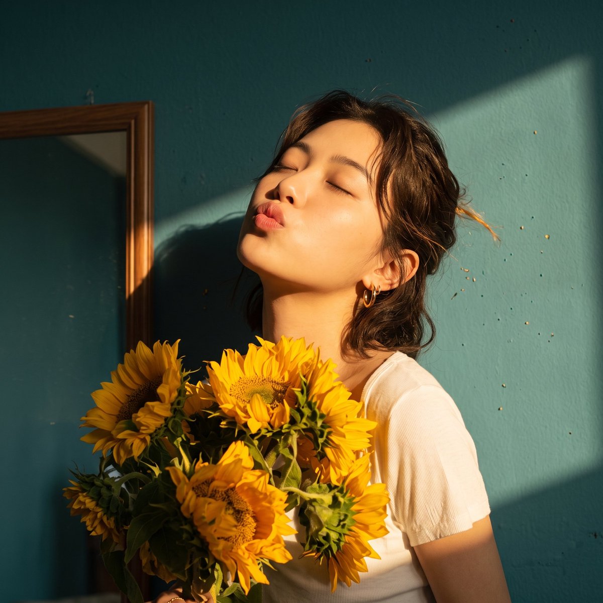 Sunflower Bouquet Held by Woman in Golden Hour Light