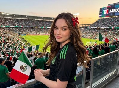 Young Mexican fan smiles in VIP stands during national team match