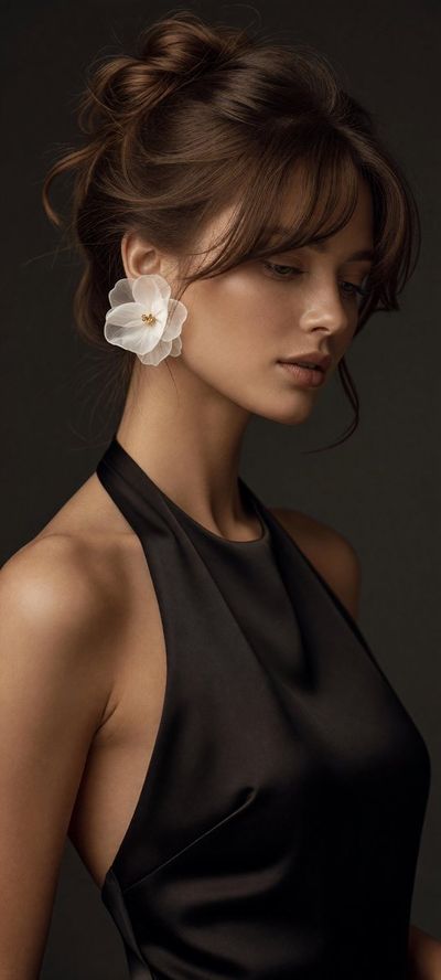 Elegant woman in black dress with flower earring