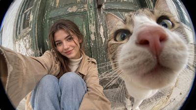 Woman and Tabby Cat Share Fisheye Selfie at Rustic Door